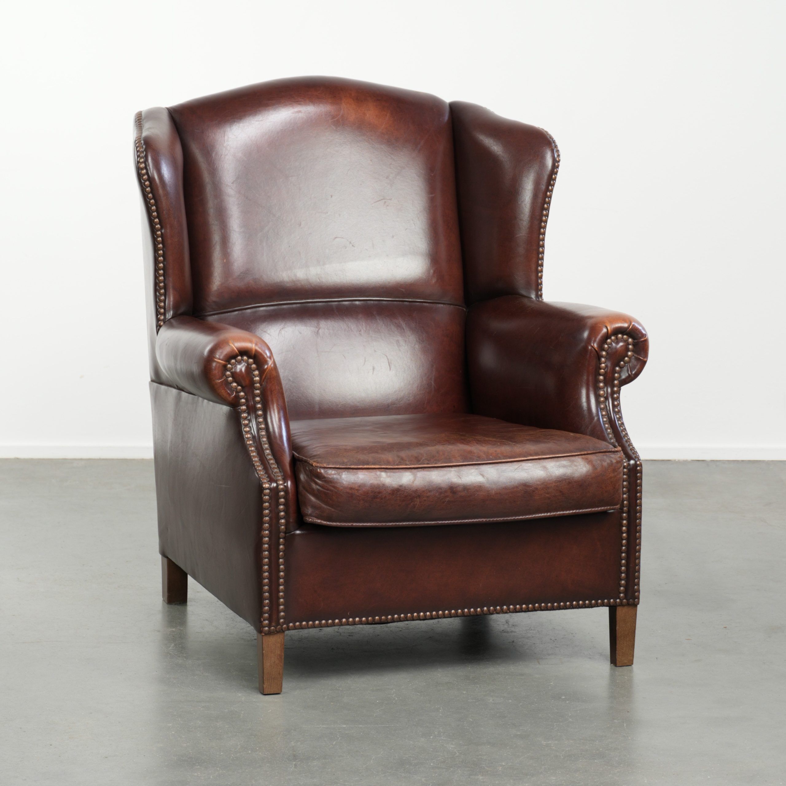Vintage sheepskin wingback armchair with a timeless English look