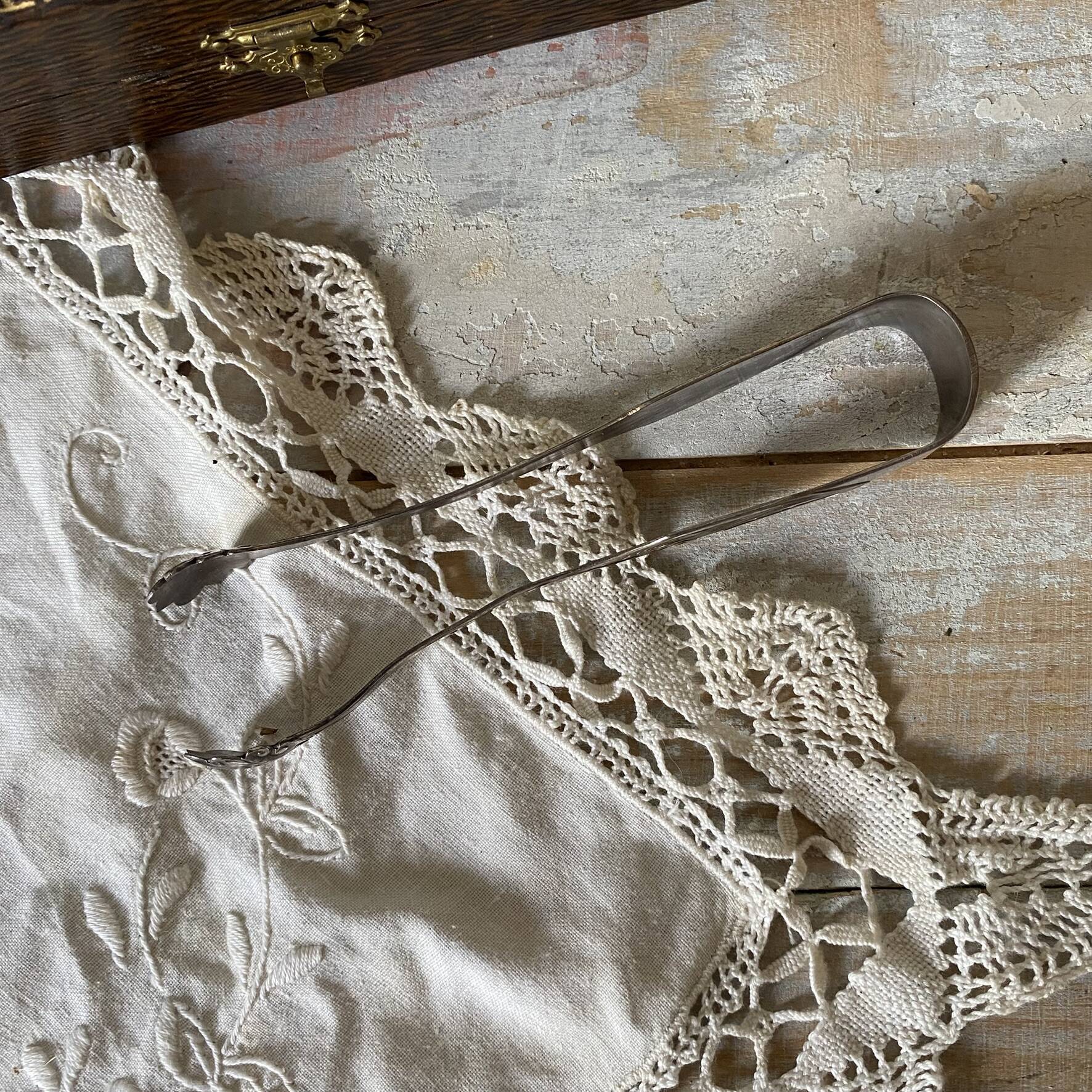 Antique sugar tongs in its case, shell decoration.