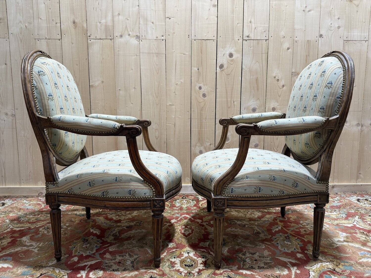 Pair of cabriole armchairs with medallion backs from the Louis XVI period, stamped OT.