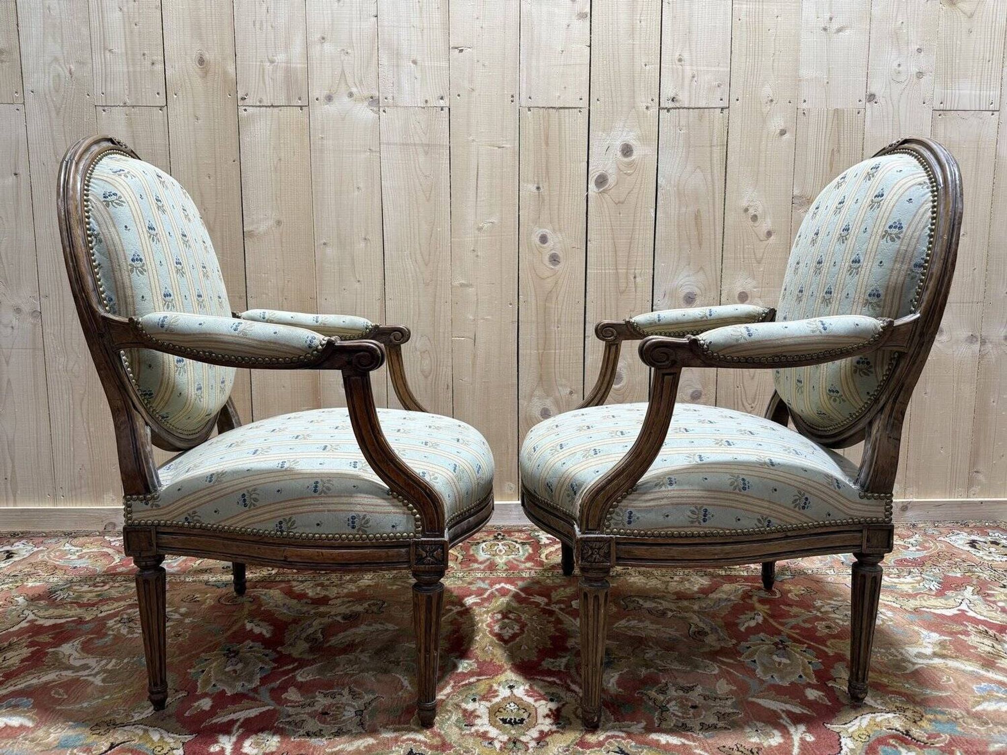 Pair of cabriole armchairs with medallion backs from the Louis XVI period, stamped OT.