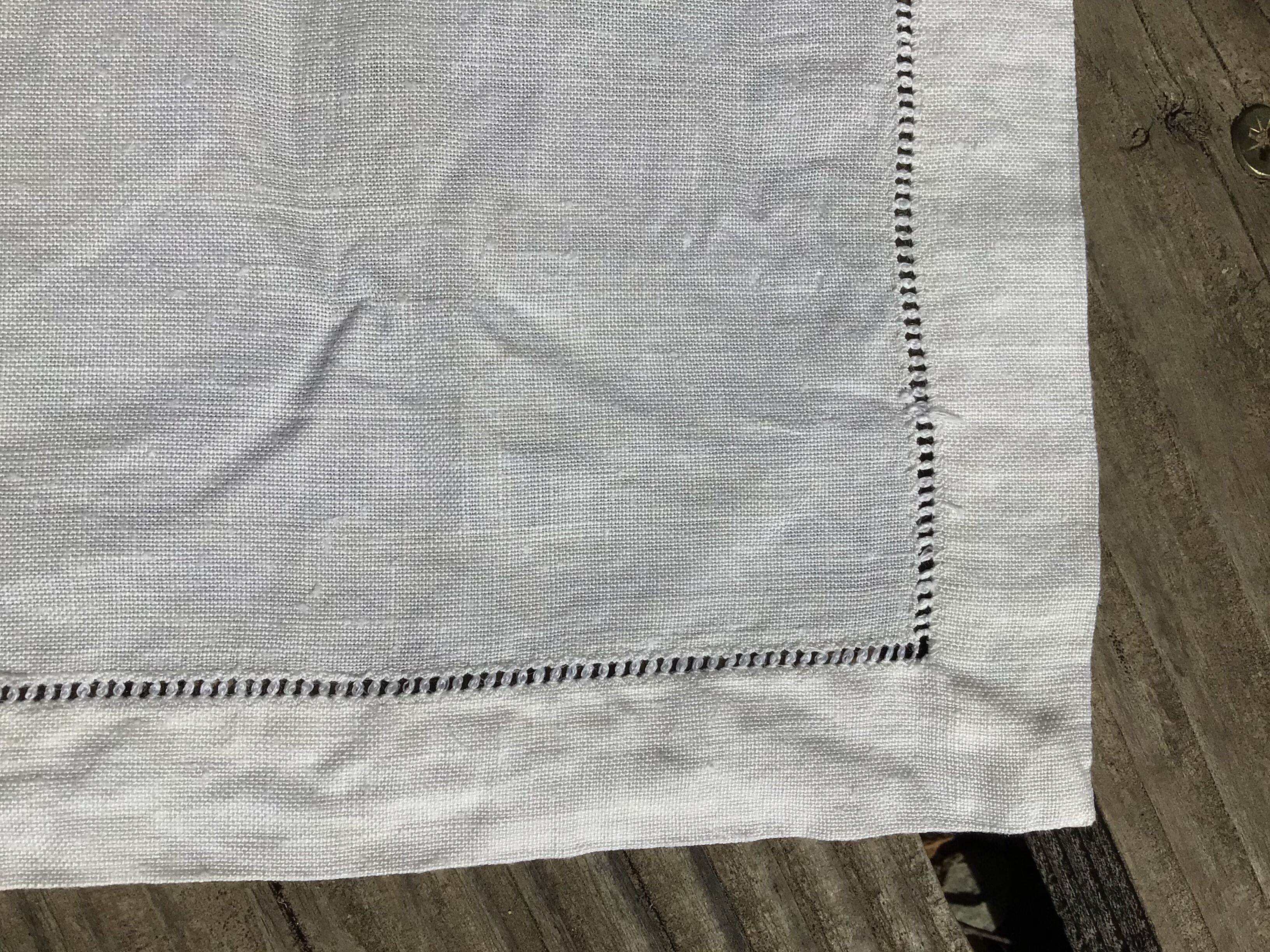 6 square linen napkins with hand-embroidered initials in the corner.