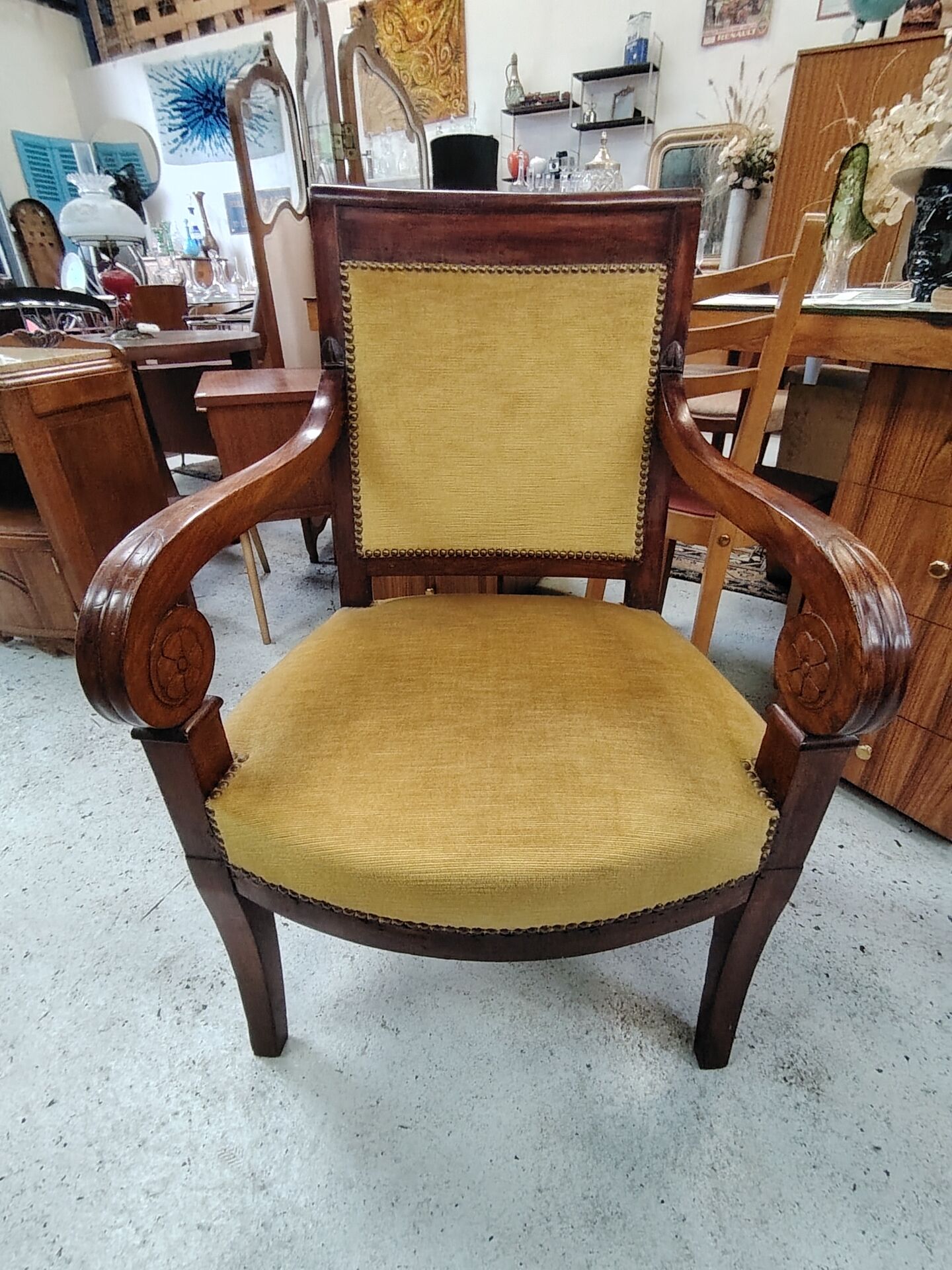 Armchair with scroll arms and sabre legs in mustard velvet, 19th century.