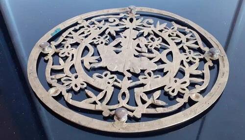 Old metal trivet