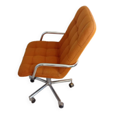 Old vintage Airborne orange armchair on wheels, adjustable in height, removable cover