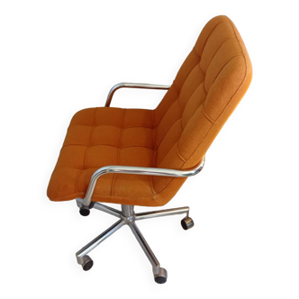Old vintage Airborne orange armchair on wheels, adjustable in height, removable cover