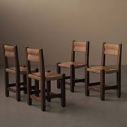 Set of four modernist chairs in oak and straw, France, circa 1960.