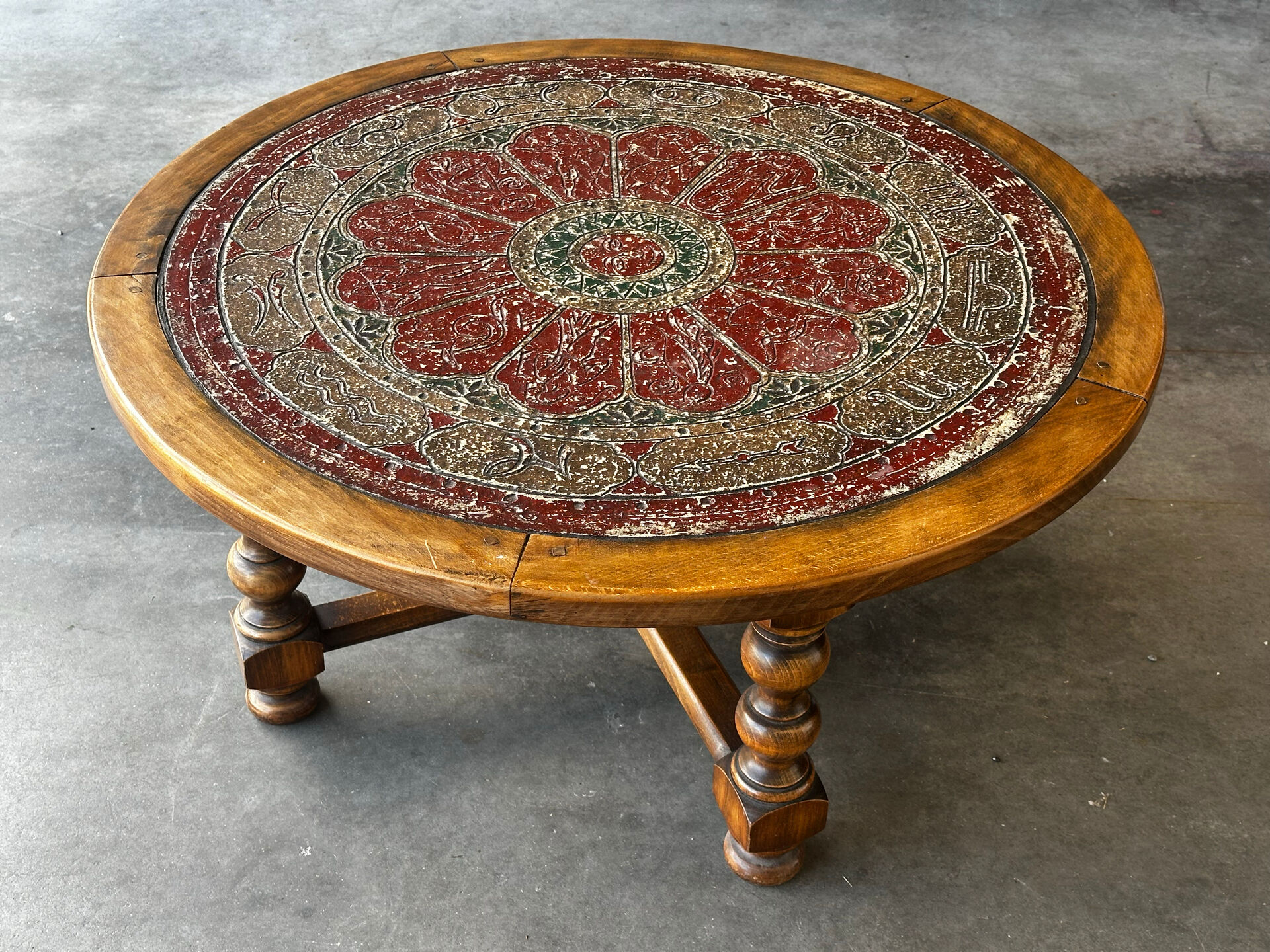 Vintage coffee table in turned wood and leather with astrological decoration.