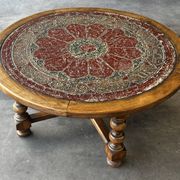 Vintage wooden turned coffee table with leather and astrological decoration.