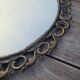 2 antique oval mirrors in heavy metal