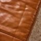 Ottoman with leather upholstery