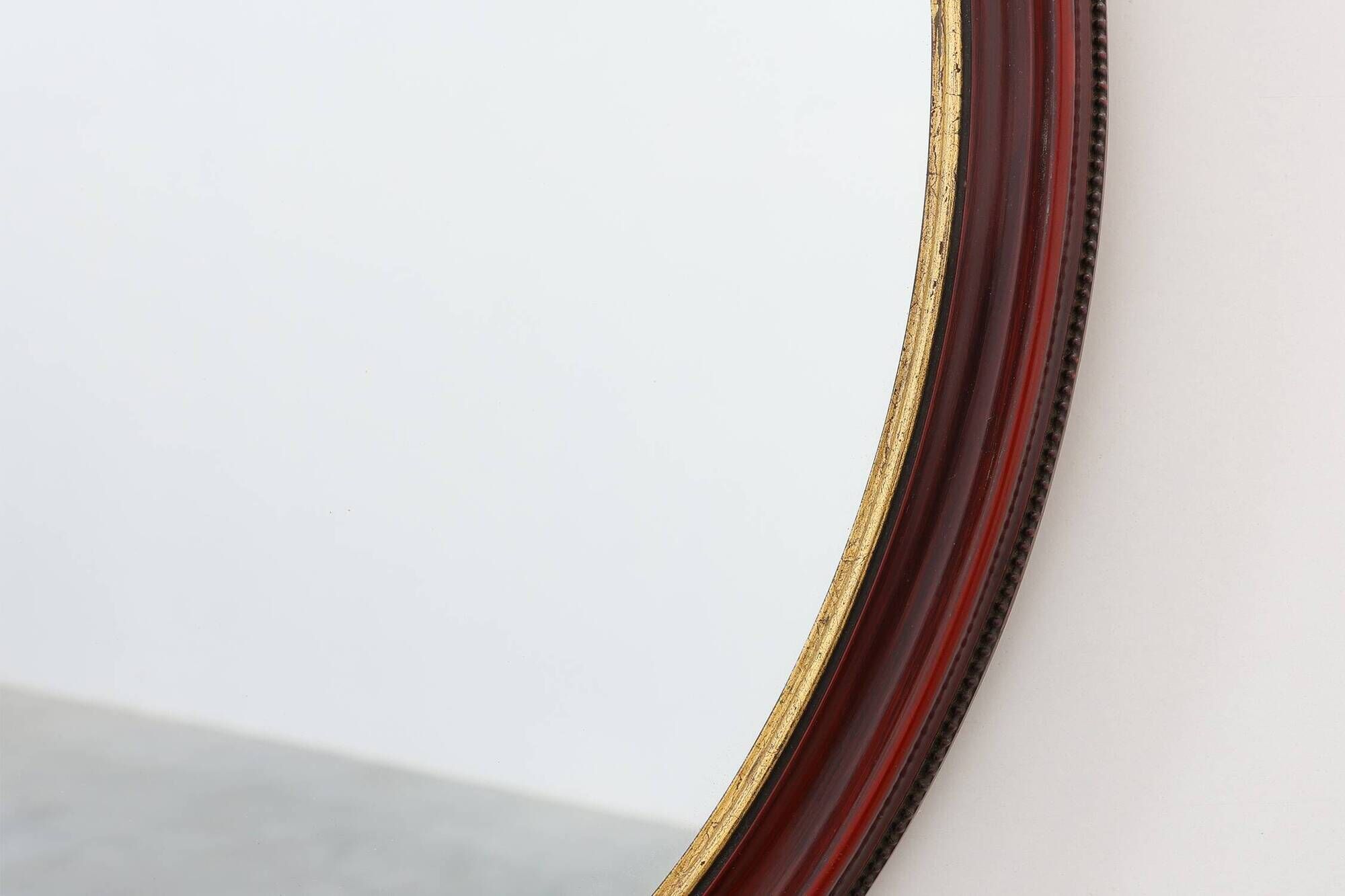 French Burgundy Lacquered Oval Mirror with Gilt Inner Edge, circa 1920