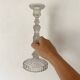 Tall molded glass candle holder with ram heads