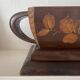 Art Deco jardinière in carved wood, decorated with roses.