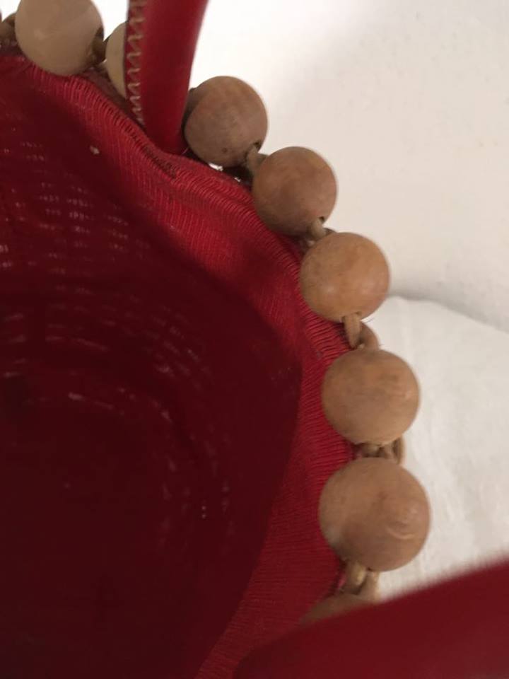 Wicker basket with a wooden bead border