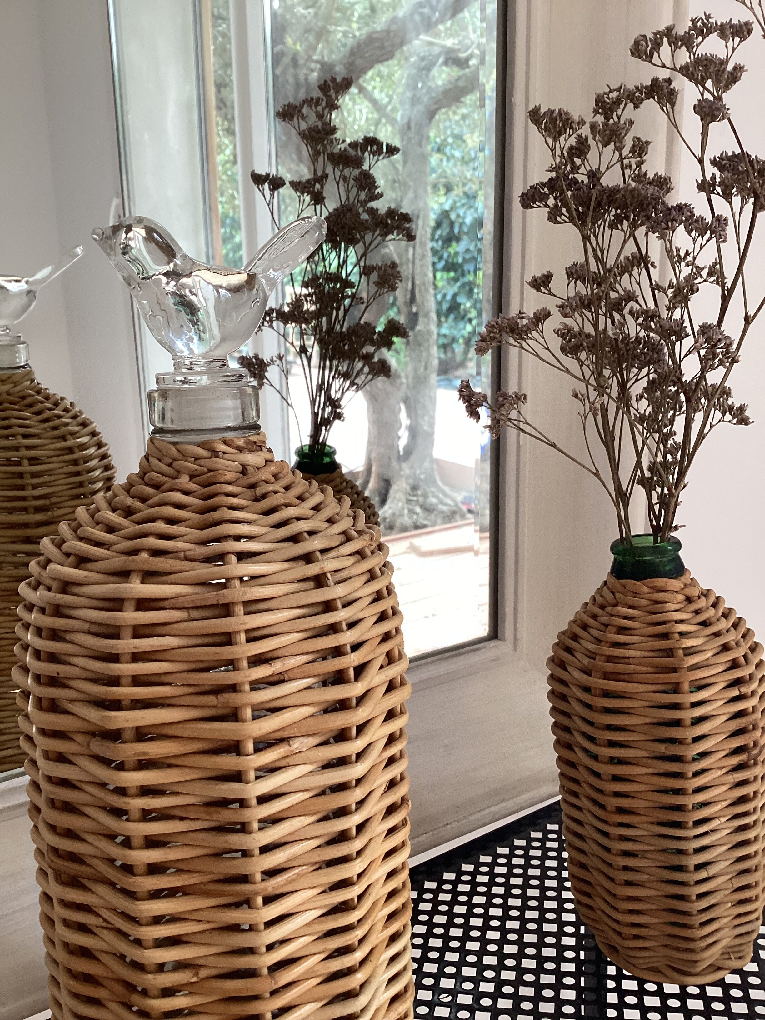 2 glass and rattan bottles