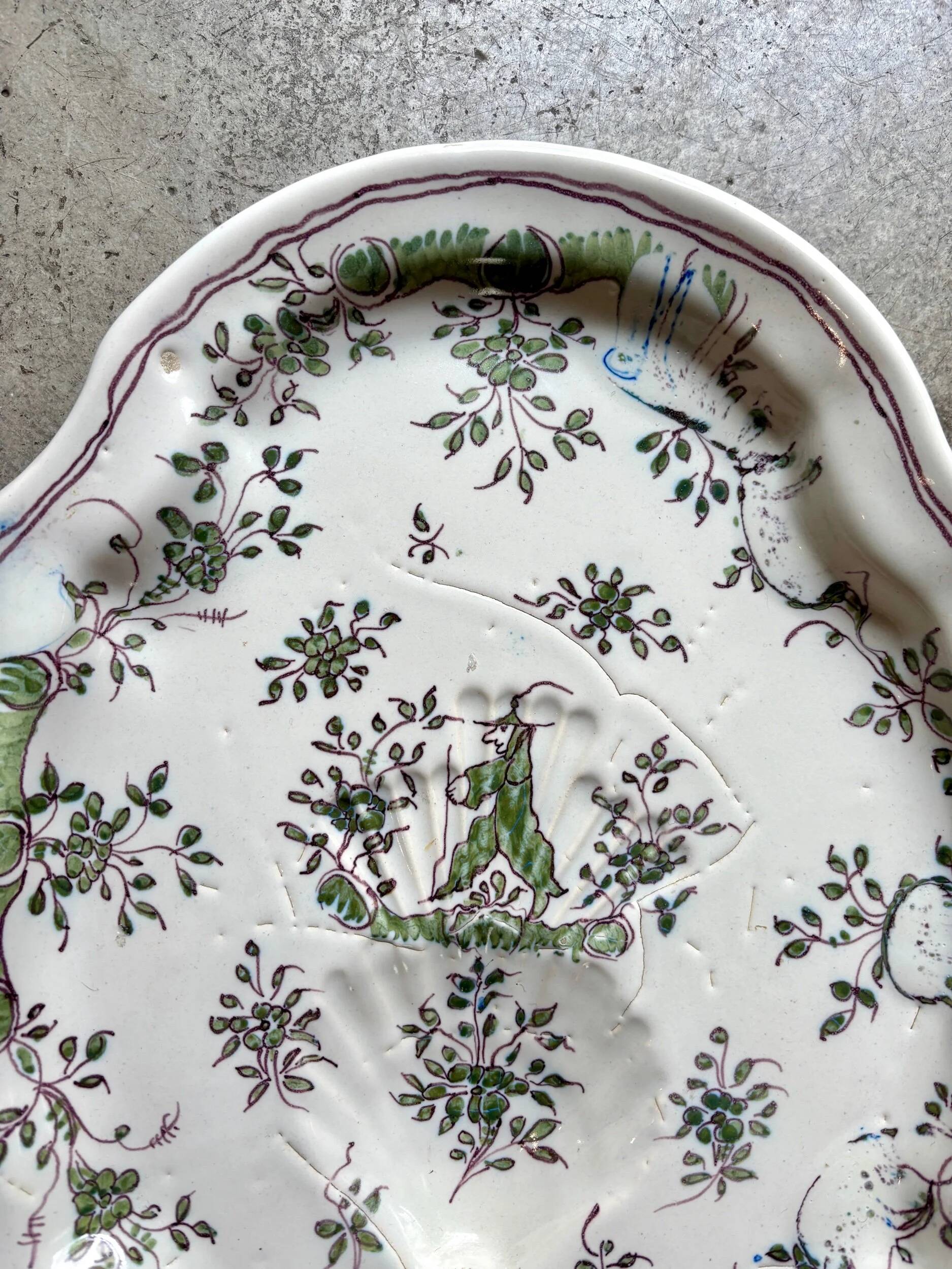 Oval Moustiers plate in cream and green earthenware, 18th century.