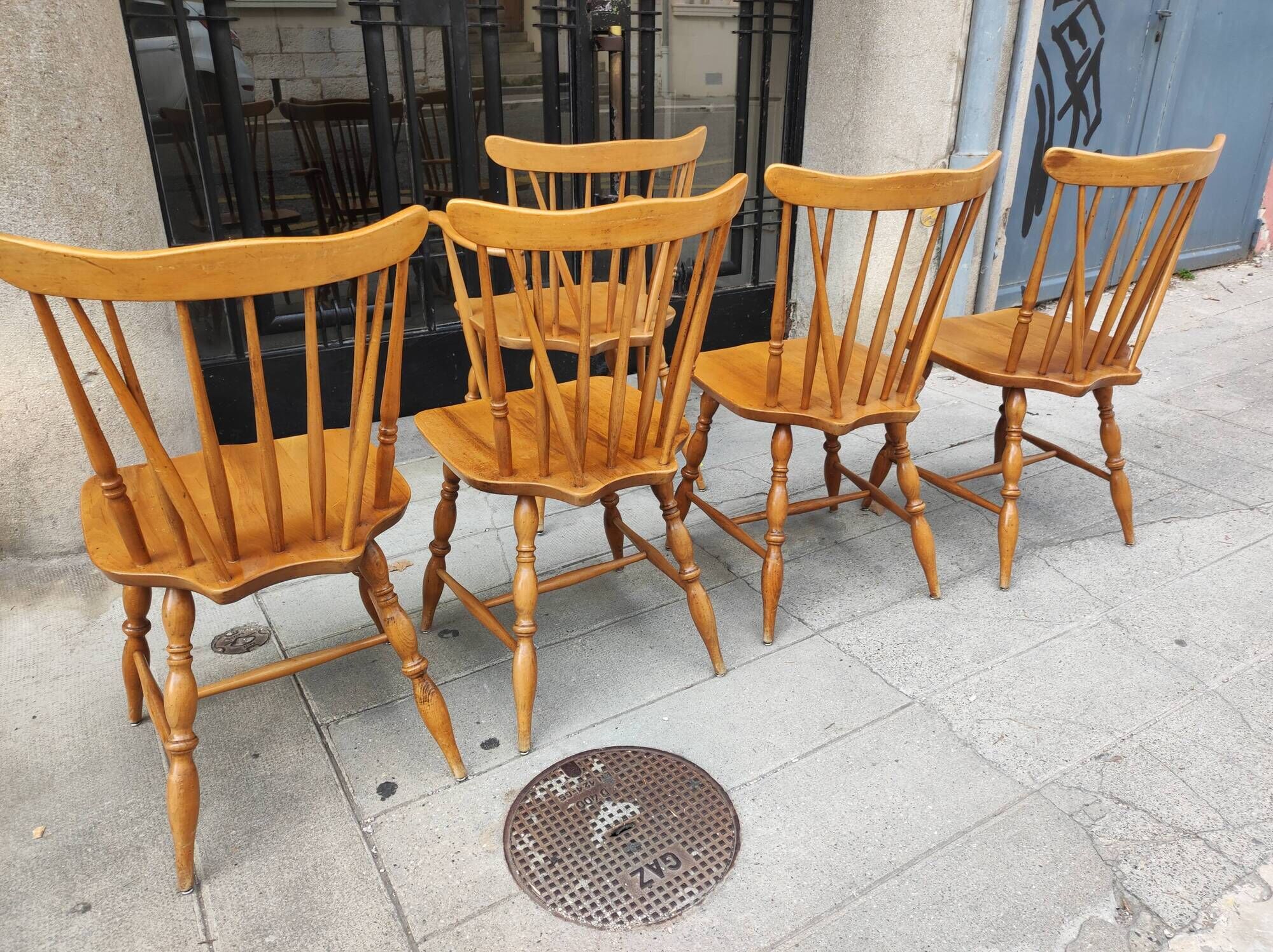 Four chairs and a Heywood Wakefield Windsor armchair. Vintage