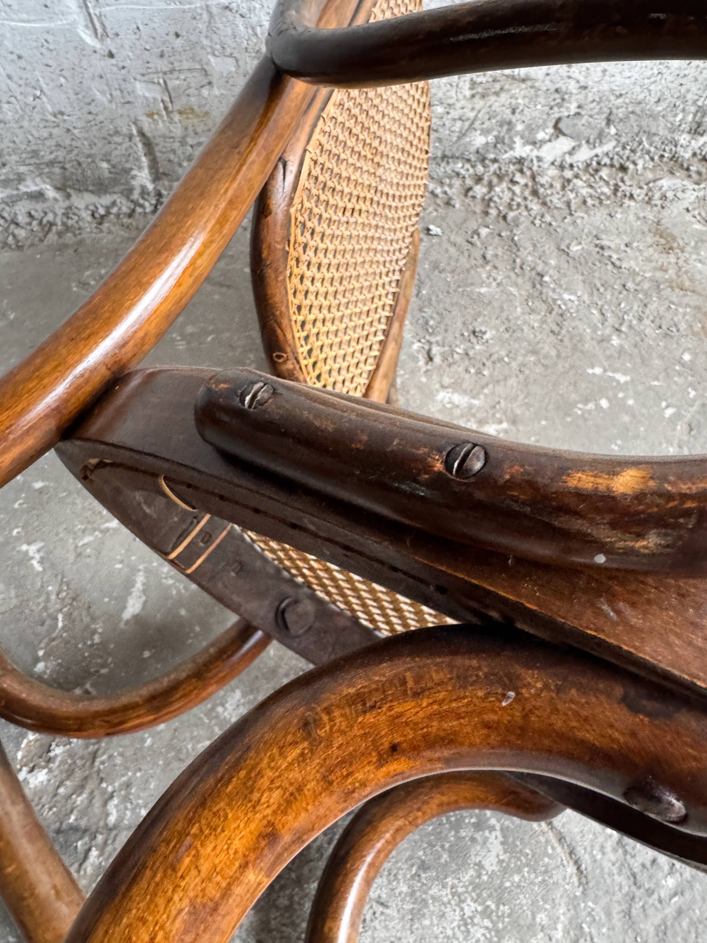 Warm walnut bentwood and cane child's rocking chair early 20th-century
