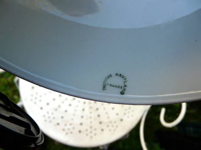 Art Nouveau wall light in bronze with a white Haviland porcelain shade.