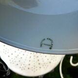 Art Nouveau wall light in bronze with a white Haviland porcelain shade.