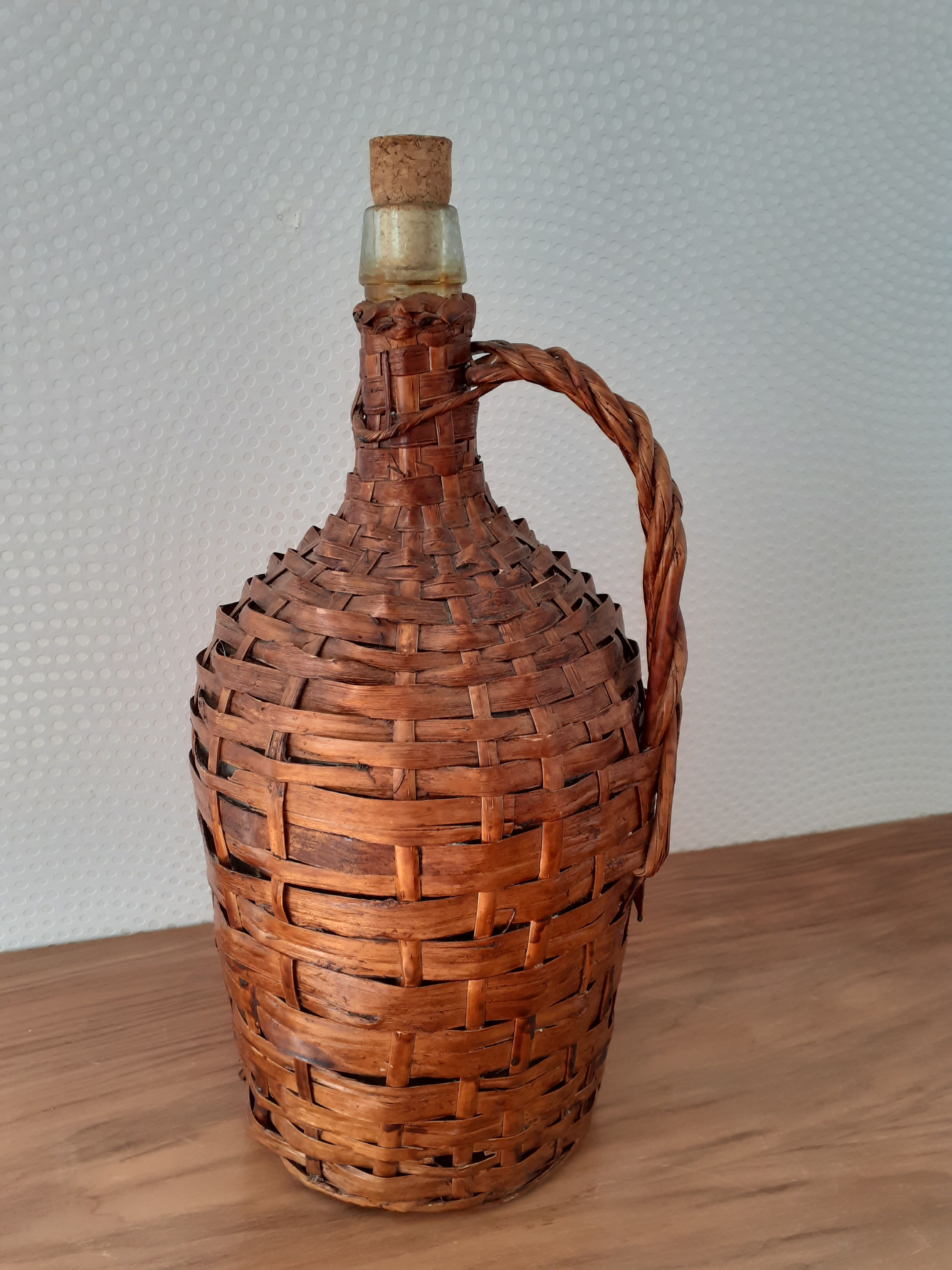 Demijohn surrounded by wicker
