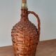 Demijohn surrounded by wicker