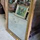 GOLDEN WOODEN MIRROR WITH PALMETTES FROM THE 19TH CENTURY