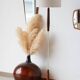 Vintage floor lamp in teak and brass with a cream shade.