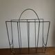 Mid-century poetic magazine rack in black metal