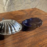 Vintage silver-plated shell butter dish with blue bowl.