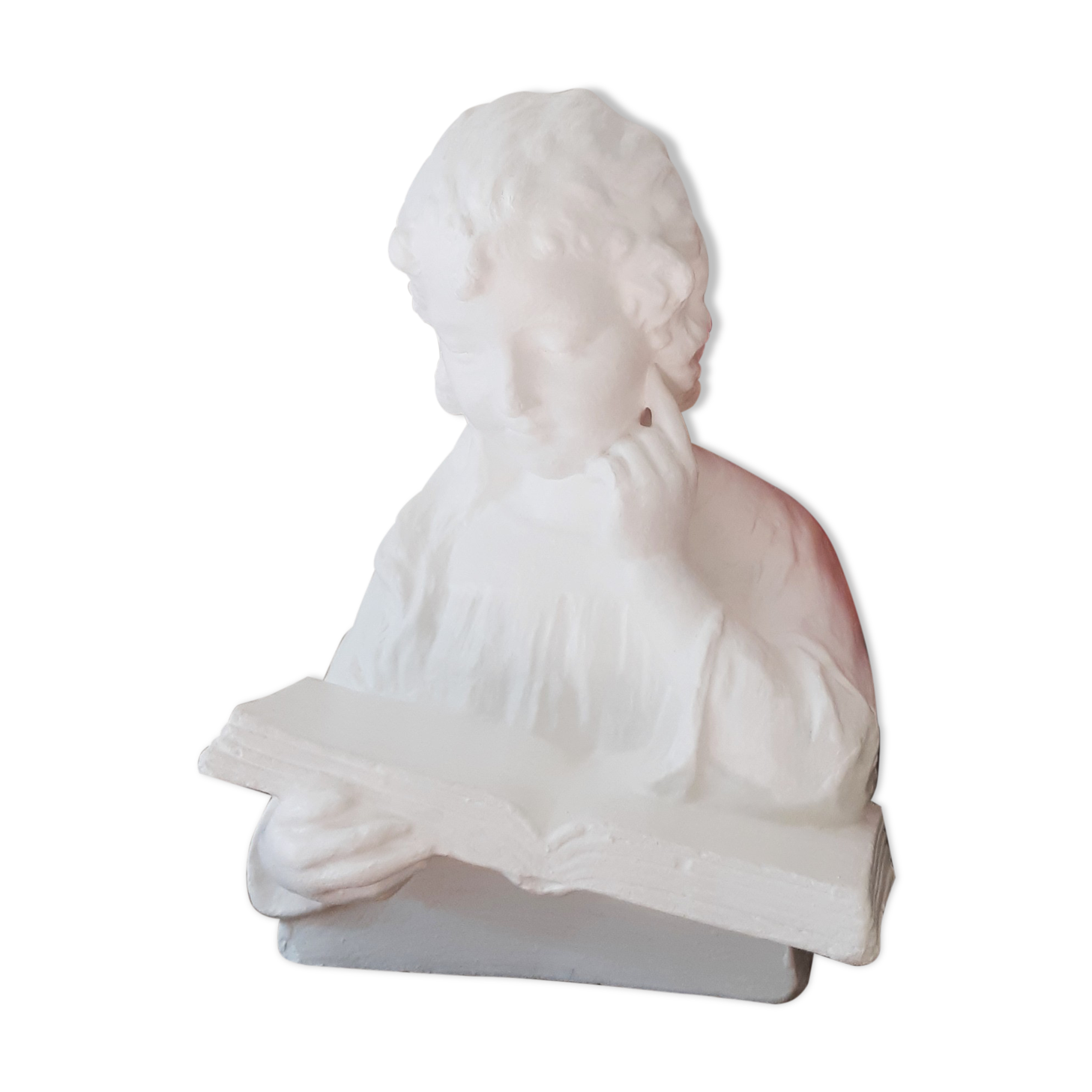 Plaster bust reading child
