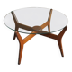 Mid-century coffee table in brown teak with a floating tempered glass top.