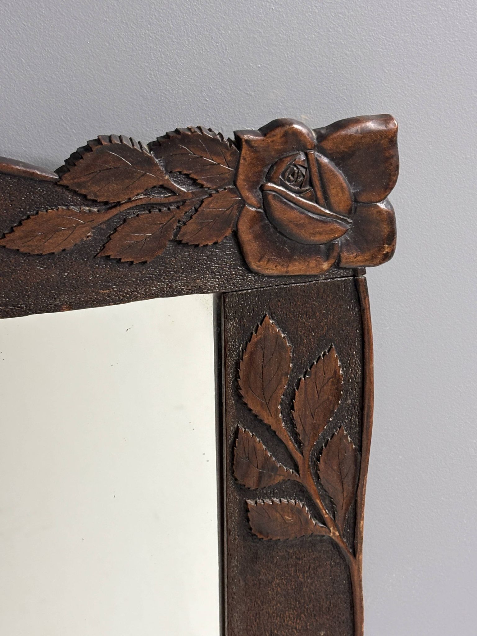Arts & Crafts hand-carved wall mirror with floral roses, early 20th century