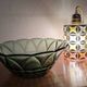 Vintage green smoked glass coupe with geometric decoration.