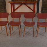 Set of 4 designer chairs in oak and red leatherette from the 1960s