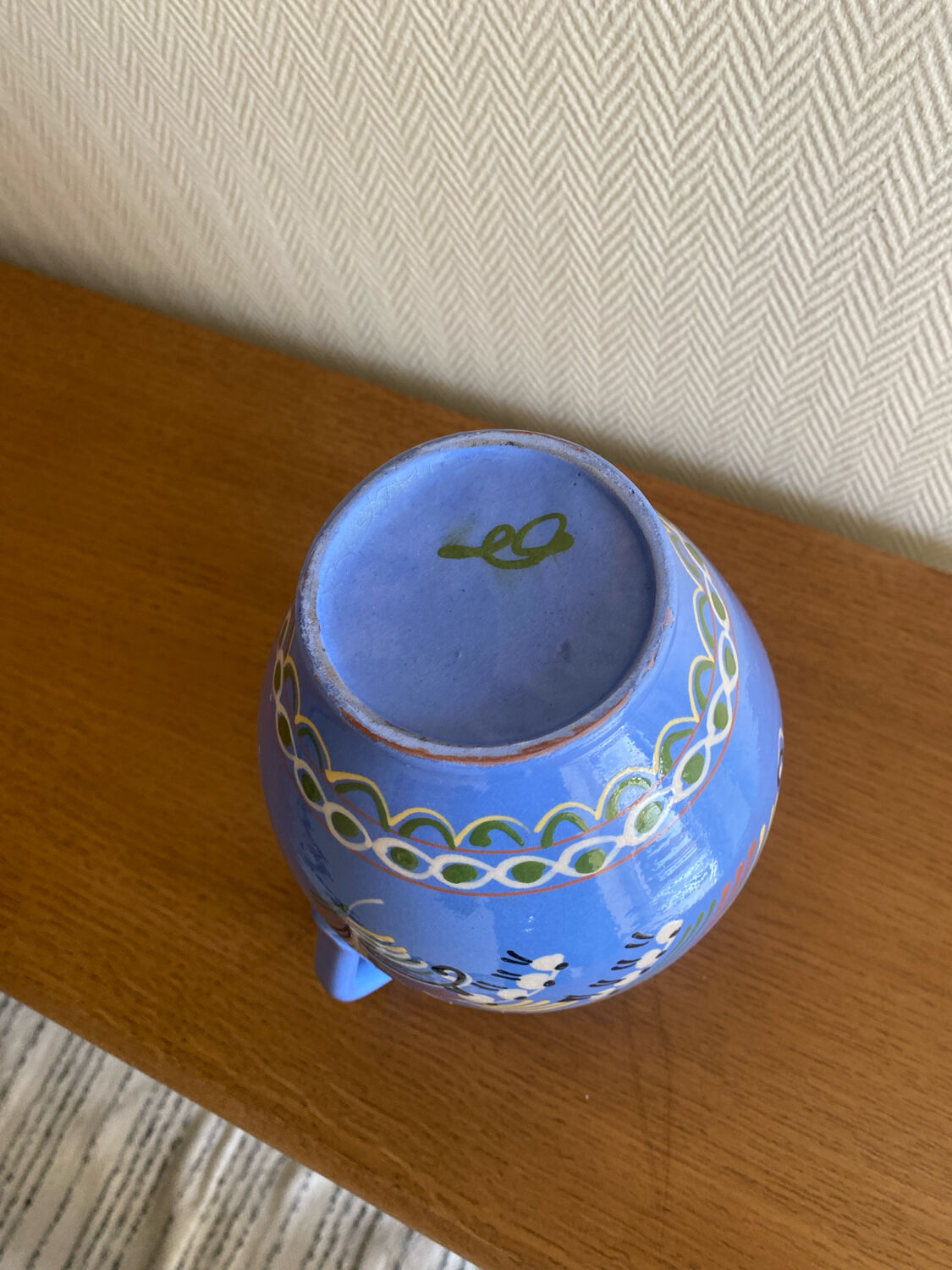 Glazed blue ceramic vase with folk decoration