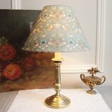 Brass candlestick lamp with its fabric lampshade by William Morris