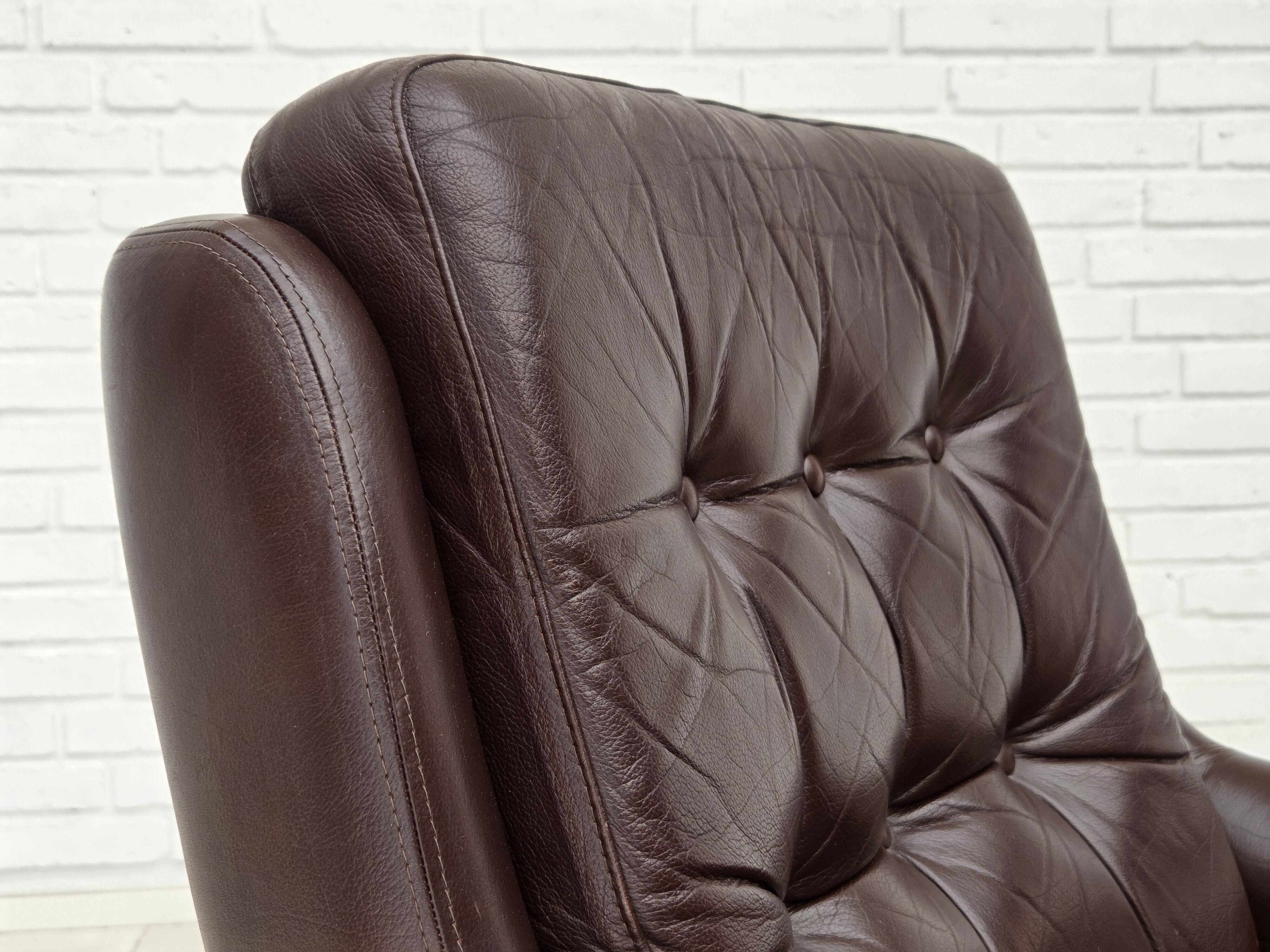 1970s, set of two swivel lounge chairs with footstool, leather.