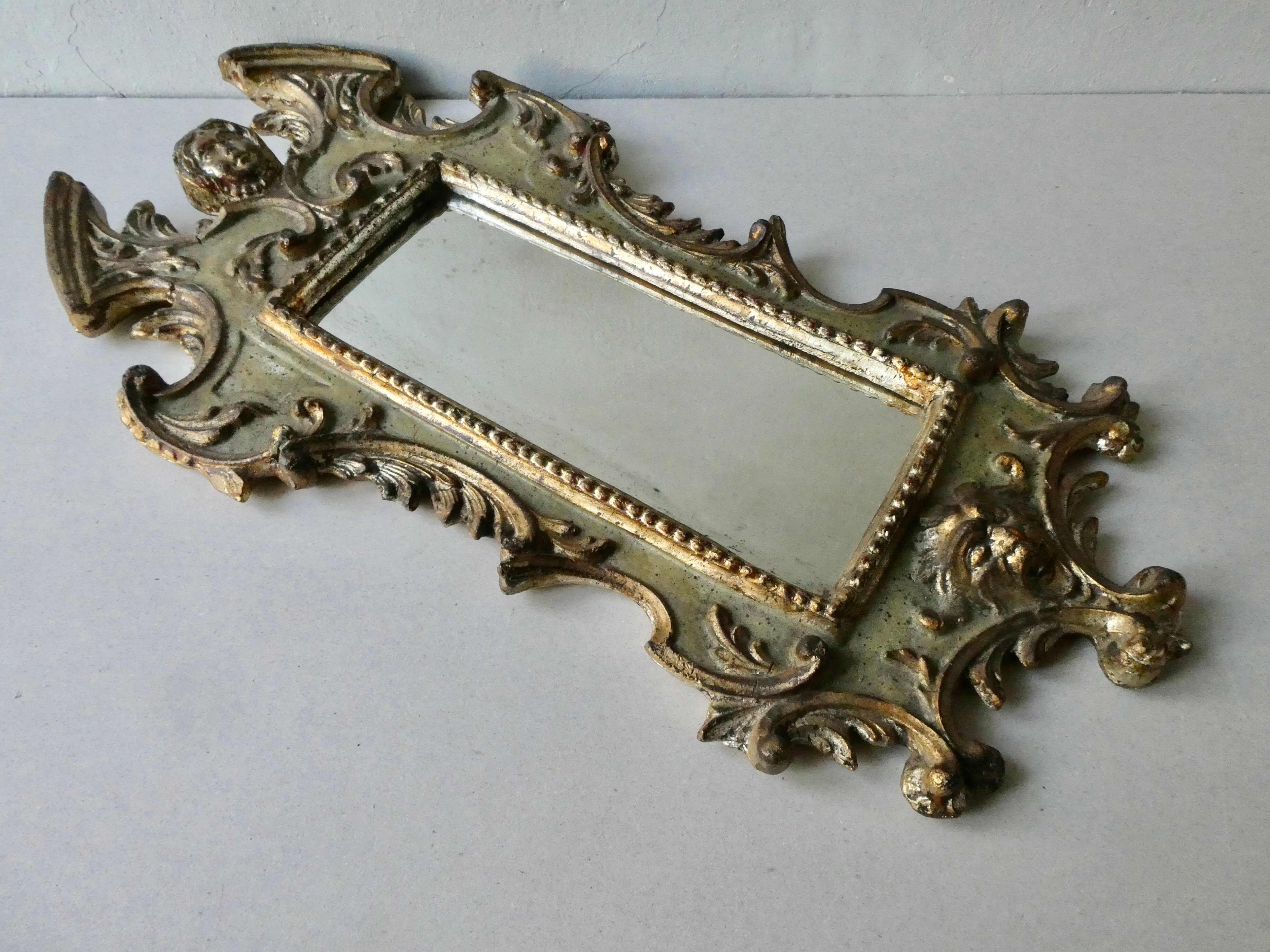 Mirror with cherub head in gilded wood, Venetian baroque style