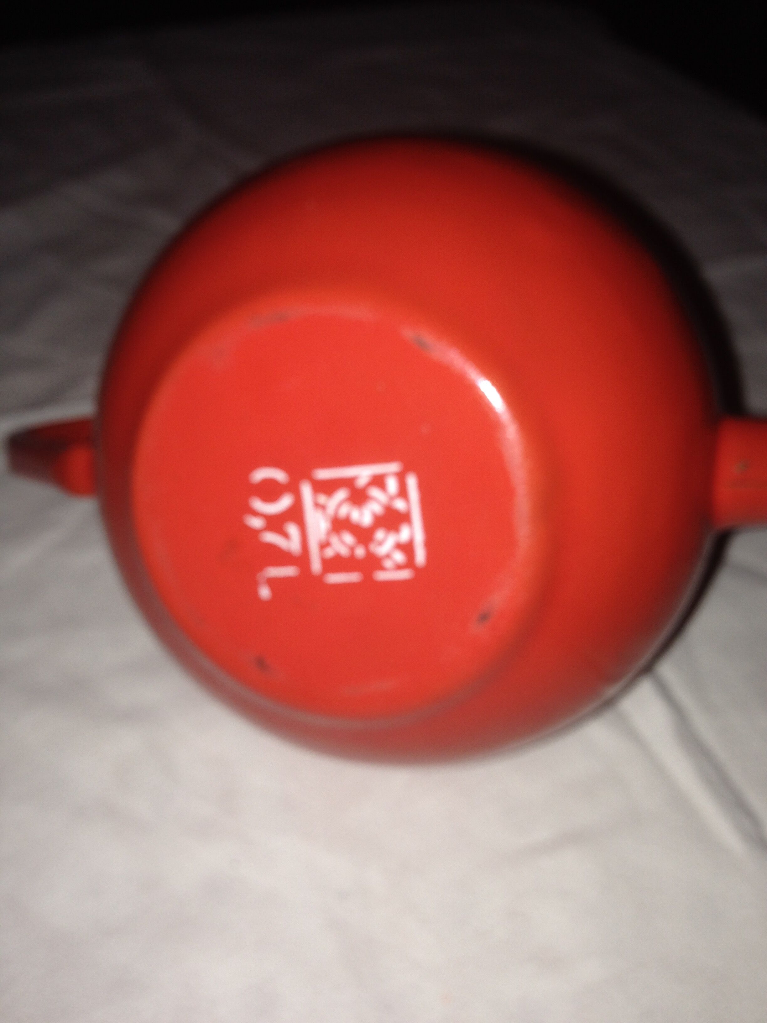 Small red metal teapot