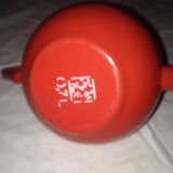 Small red metal teapot
