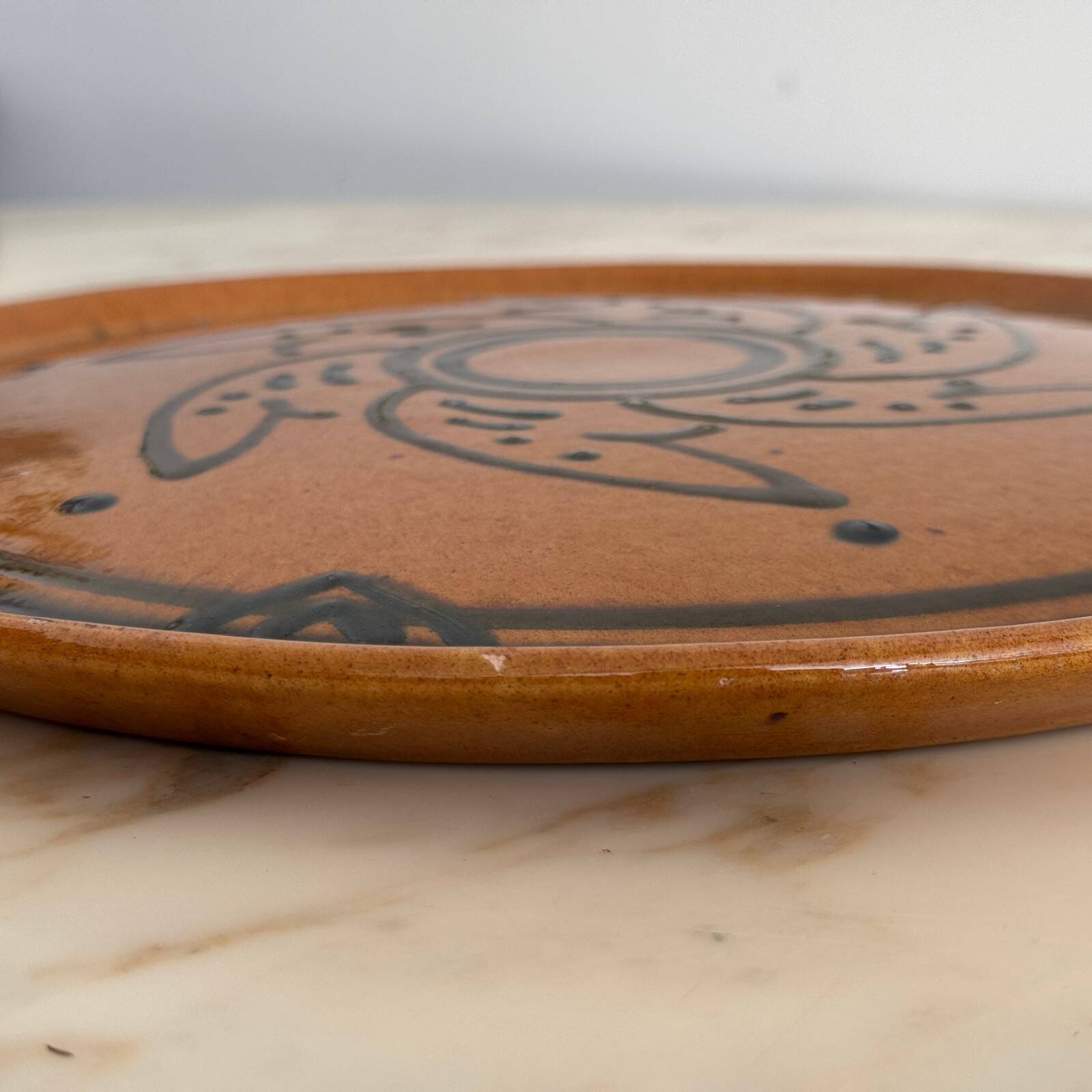 Round glazed earthenware dish by Biot, 20th century, stylized decoration