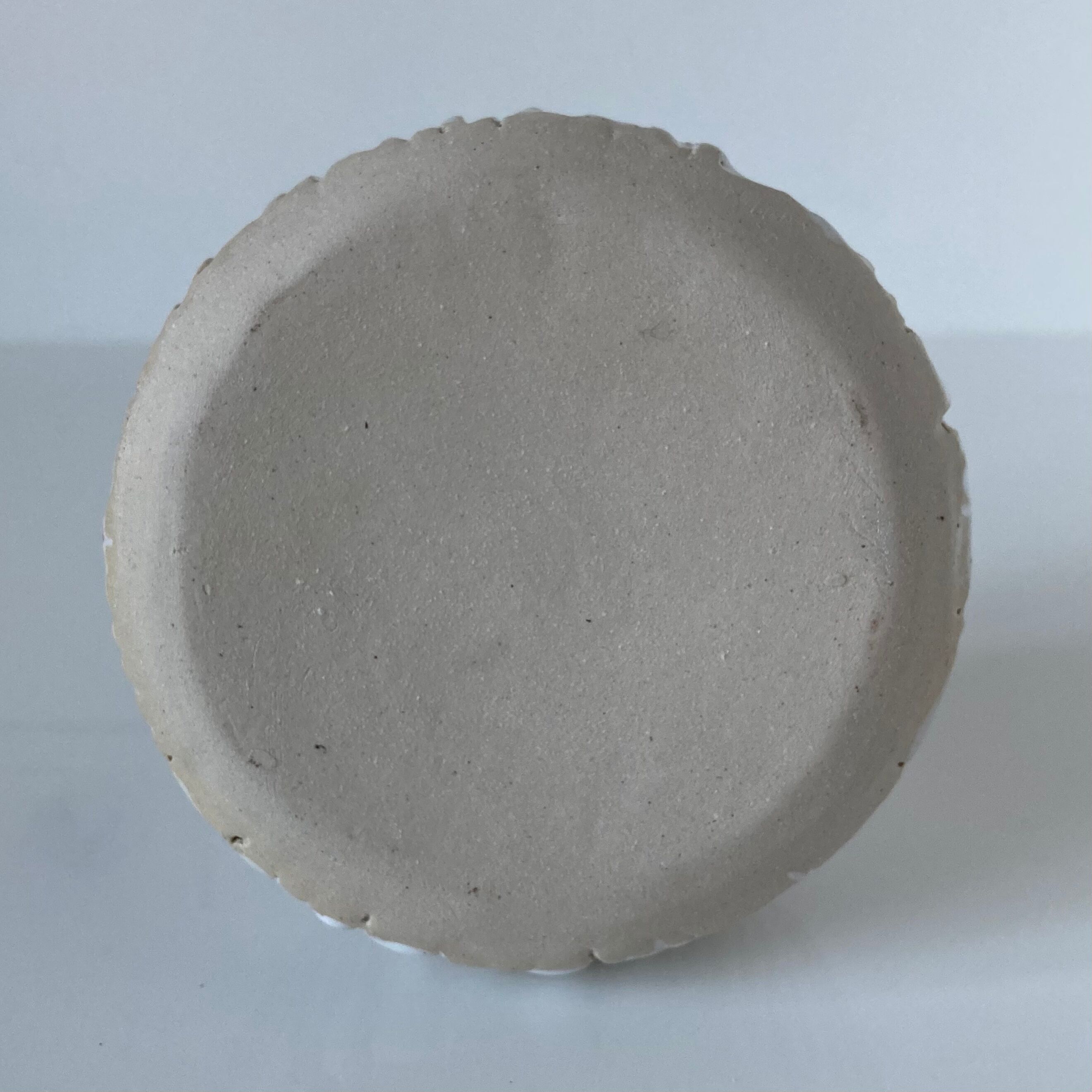 Meeting of three artist's ceramic objects including two pots and a cream covered bowl