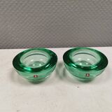 A set of iitalla candle holders in green transparent glass.
