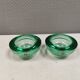 Un ensemble de porte-bougies iittala en verre transparent vert.