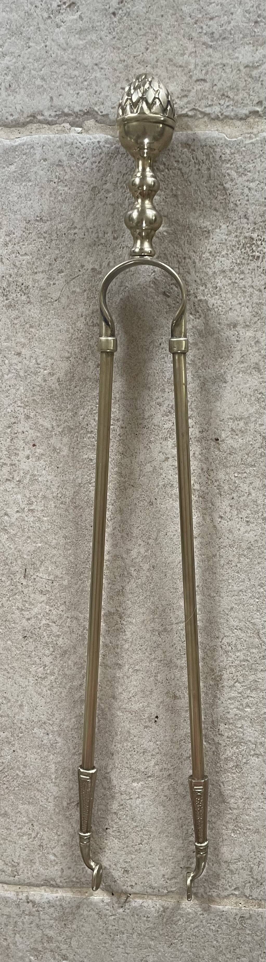 Brass fireplace tools in the style of Maison Baguès.