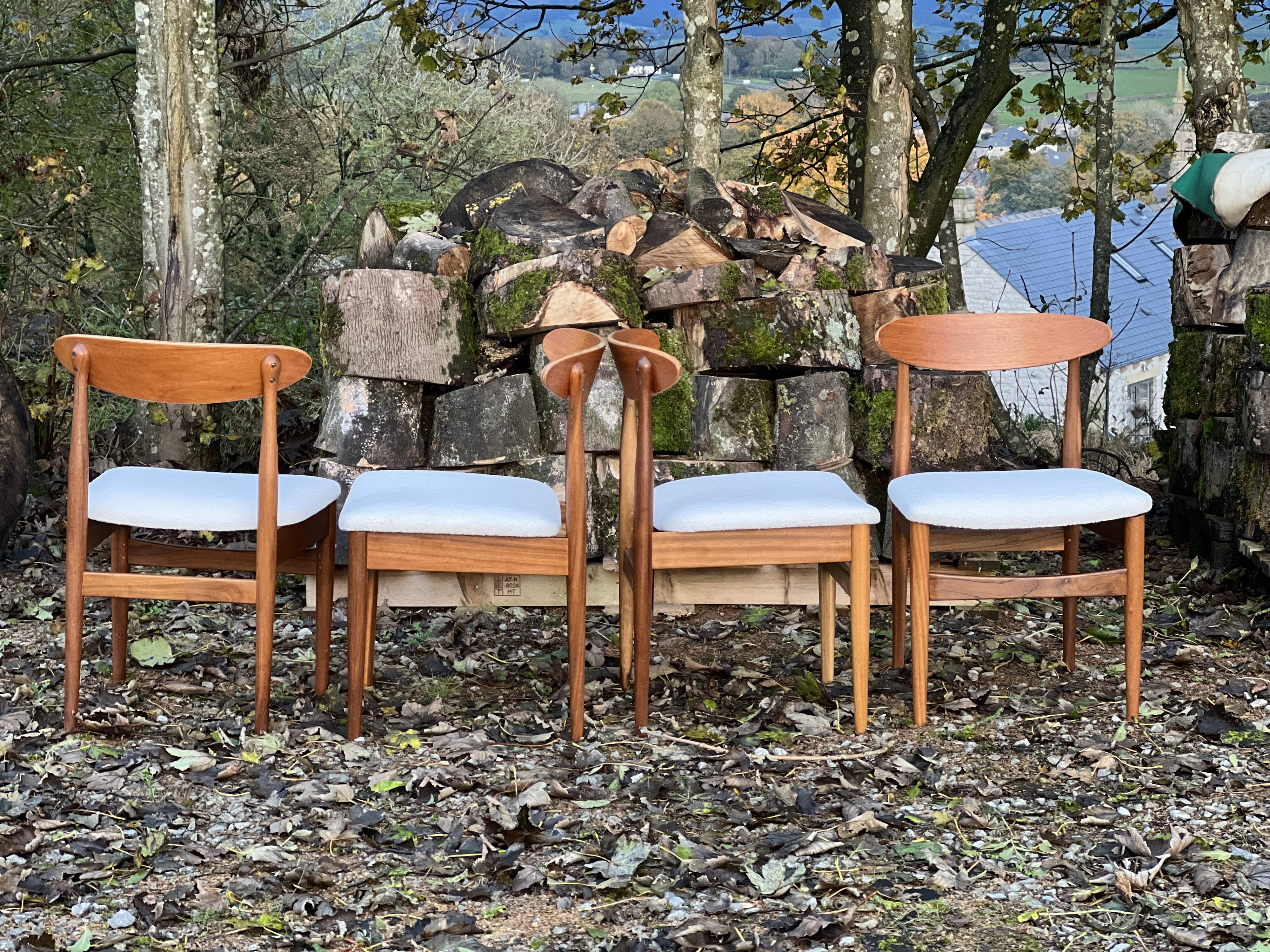 A set of GPlan chairs in teak with a white woolly fabric