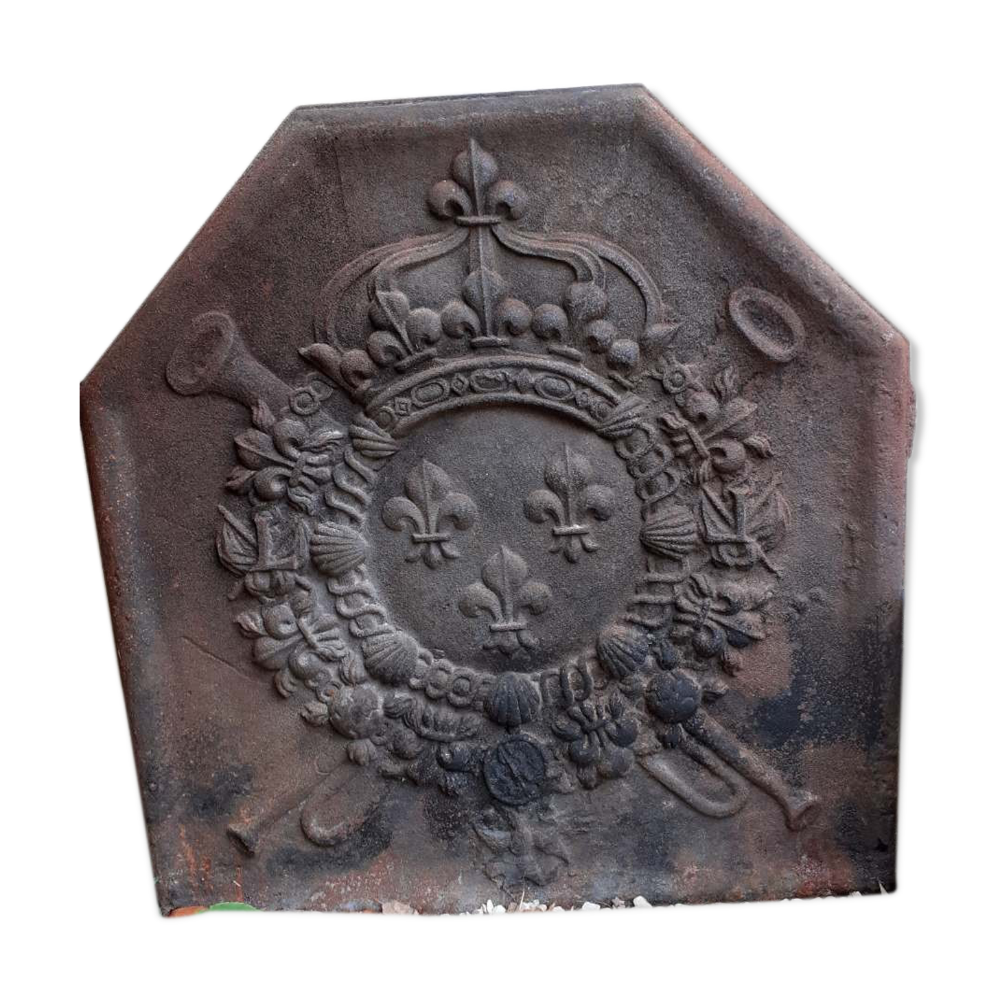 Old cast iron fireplace plate with lily flowers