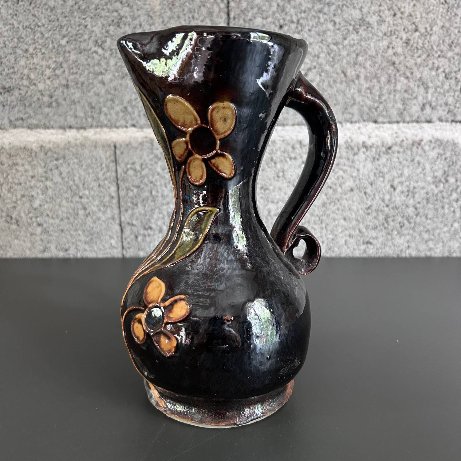 Black vase with yellow flowers