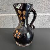 Black vase with yellow flowers